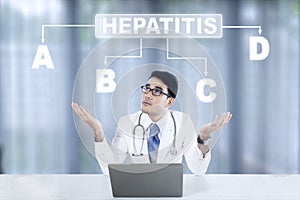 Pensive doctor looking at hepatitis word