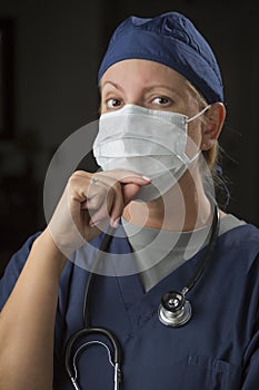 Pensive Doctor or Nurse Wearing Protective Face Mask
