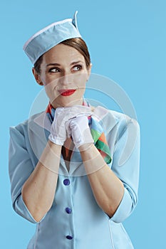 pensive elegant air hostess woman on blue