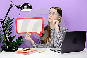 Pensive employee young business woman sitting work at white office desk with laptop empty blank Say cloud speech bubble