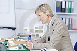 Pensive experienced female architect at work in office