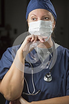 Pensive Female Doctor or Nurse Wearing Protective Face Mask