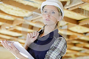 pensive female inspector in renovation property