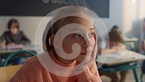 Girl schooling in classroom. Portrait of female student boring during lesson