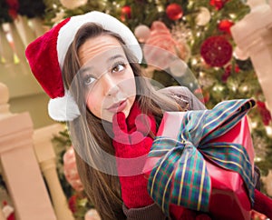 Pensive Girl Wearing A Christmas Santa Hat with Bow Wrapped Gif