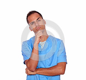 Pensive guy nurse standing with hand on chin