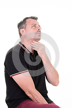 Pensive handsome man looking up and touching chin thinking standing isolated over white background