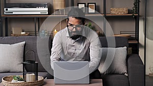 Pensive Indian Businessman Working With Laptop At Home