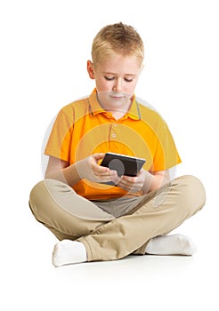 Pensive kid boy sitting with tablet pc or phablet isolated photo