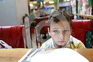 Pensive kid in restaurant