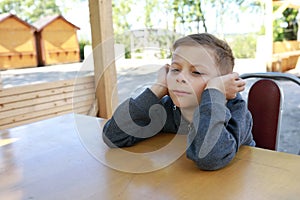 Pensive kid waiting food