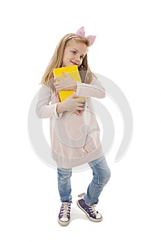 Pensive little girl holding a books