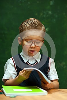 Pensive Little school boy with trendy haircut