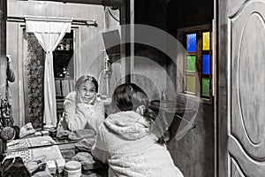 Pensive lonely woman facing the mirror