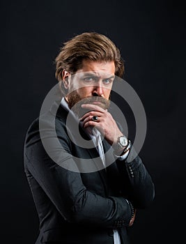 pensive look. fashionable man wear hand watch. formal fashion model. handsome man on gray background. serious bearded