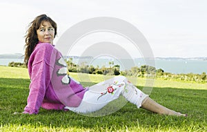 pensive looking mature woman in park.