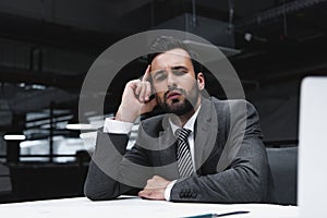 pensive male architect in suit working