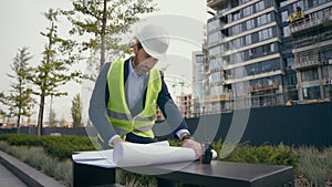 Pensive male architect thoughtful looking around think check urban infrastructure manufacture blueprint thinking worker