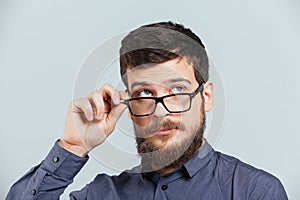 Pensive man in glasses looking up