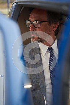 Pensive man seated in chopper looking away photo