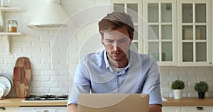 Pensive man thinking over issue solution while working on laptop