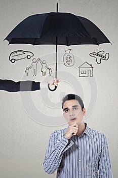 Pensive man under umbrella