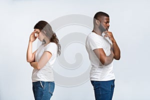 Pensive man and woman standing back to back after quarrel