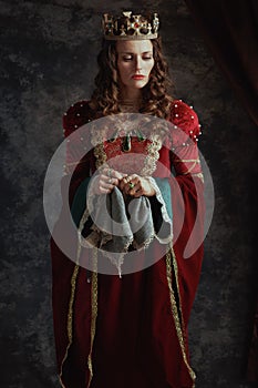 pensive medieval queen in red dress with handkerchief