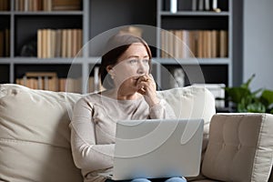 Pensive middle-aged woman look in distance pondering