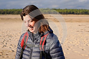 Pensive middle aged woman walking along sea coast beach