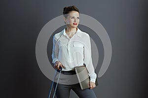 pensive modern business woman against gray background