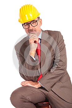 Pensive old construcion engineer sitting
