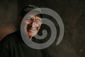 Pensive old man in glasses with gray hair