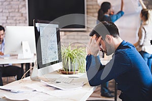 Pensive overworked architect working on corporate project