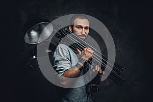 Man is carrying lamp at photo studio