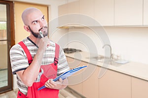 Pensive plumber in the kitchen