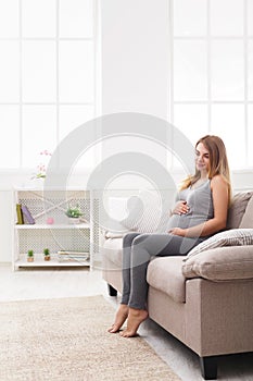 Pensive pregnant woman dreaming about child