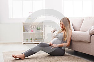 Pensive pregnant woman dreaming about child