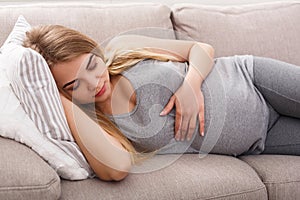 Pensive pregnant woman dreaming about child