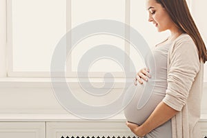 Pensive pregnant woman dreaming about child