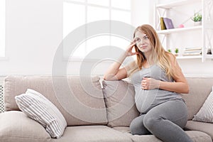 Pensive pregnant woman dreaming about child