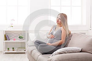 Pensive pregnant woman dreaming about child