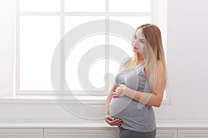 Pensive pregnant woman dreaming about child