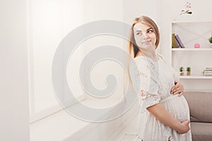 Pensive pregnant woman dreaming about child