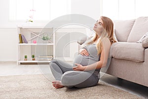 Pensive pregnant woman dreaming about child