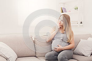 Pensive pregnant woman dreaming about child