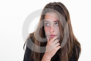 Pensive pretty brunette young woman looking side with hands on chin isolated in white background