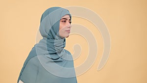 Pensive and puzzled Arabian woman pondering on beige background