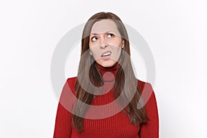 Pensive puzzled young brunette woman girl in casual red clothes posing isolated on white wall background studio portrait