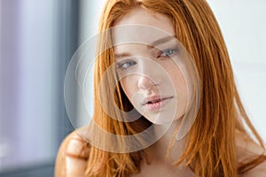 Pensive redhead woman looking away